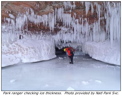 Park ranger checking ice thickness